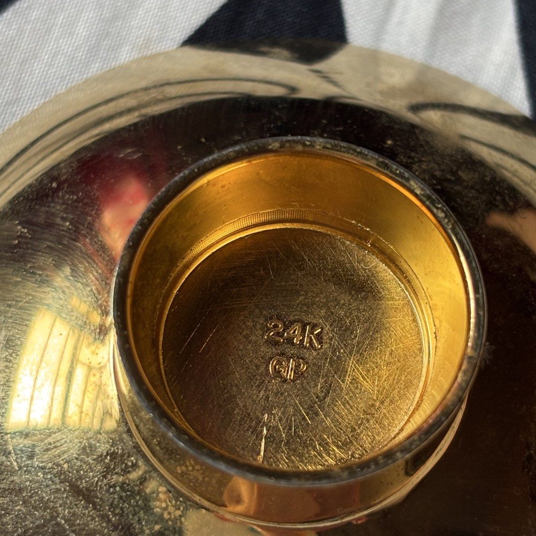 24K Gold Plated Small Bowl Dish (Category: Dinnerware & Cutlery) located in Manila. Submitted by tiffanyyyy09 (Listing ID 1467741686, Image 1). Description: - Type: Small decorative bowl - Finish: Brushed interior, shiny polished exterior and base - Material: Sturdy metal stamped with 24K GP on the bottom - Design: Circular shape with a raised interior medallion and traditional stylized center emblem - Condition: Excellent with minimal surface sc