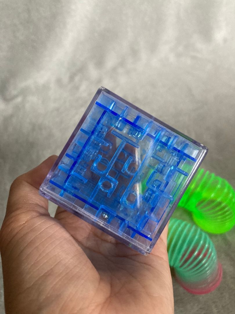 3D Maze Cube and Rainbow Spring Slinky Toys (Category: Infant Playtime) located in Rizal. Submitted by sheeraay (Listing ID 1467702777, Image 2). Description: - Fun fidget toy bundle for kids or stress relief - Includes 1x clear blue 3D puzzle maze cube with a rolling silver ball - Includes 2x plastic slinkies (neon green and rainbow colors) - Clean condition and ready to play.