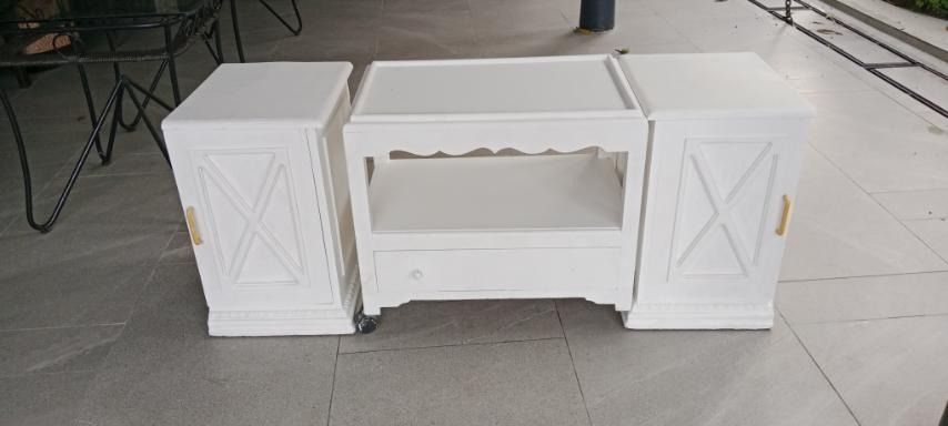 3-Piece White Modular TV Console Table & Side Storage Cabinets Set (Category: TV Consoles) located in Taytay. Submitted by airamgarcia (Listing ID 1467696489, Image 1). Description: Description: Clean and versatile 3-piece white entertainment center console set. Features a center media console table with an open shelf for media devices/consoles and a bottom drawer, flanked by two matching side storage cabinets with decorative "X" motif doors and 