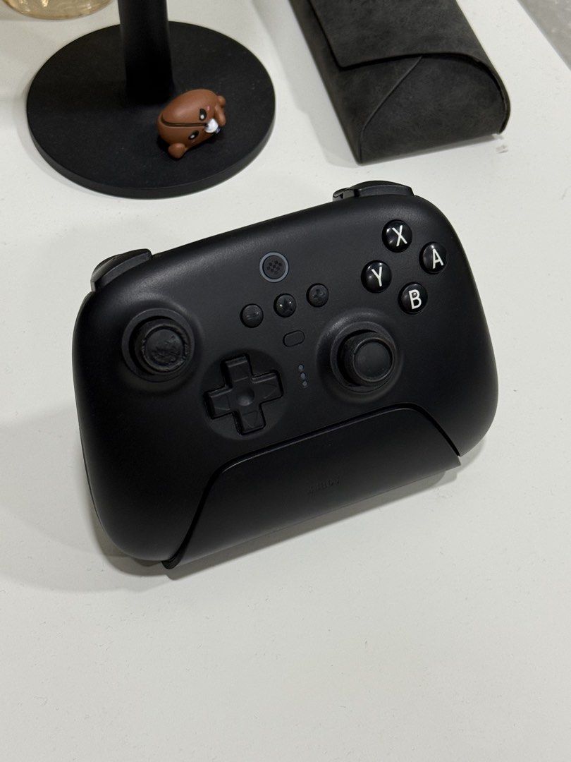 8BitDo Bluetooth Controller (Category: Controllers) located in Rembau. Submitted by aenasydh17 (Listing ID 1467745061, Image 1). Description: Details: -Brand: 8BitDo -Model: First version (original version) -Colour: Black -Condition: Used, with visible wear on the left analogue stick (as shown in the pictures) -Still fully functional (can dm me for video) 💰 Price: RM80 📍 Location: Negeri Sembilan 📦 Postage / COD: Can dm me Any inquiries just d