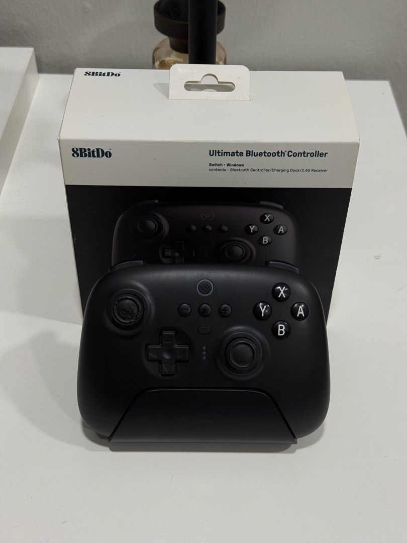 8BitDo Bluetooth Controller (Category: Controllers) located in Rembau. Submitted by aenasydh17 (Listing ID 1467745061, Image 2). Description: Details: -Brand: 8BitDo -Model: First version (original version) -Colour: Black -Condition: Used, with visible wear on the left analogue stick (as shown in the pictures) -Still fully functional (can dm me for video) 💰 Price: RM80 📍 Location: Negeri Sembilan 📦 Postage / COD: Can dm me Any inquiries just d