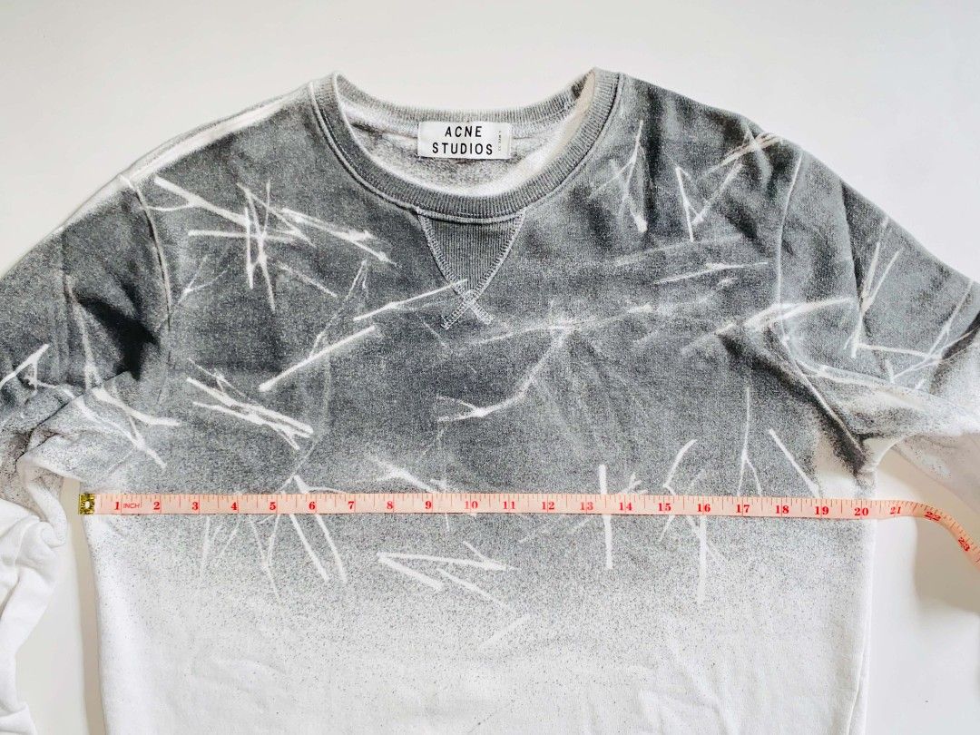 Acne Studios Gradient Spray Paint Sweatshirt (Category: Coats, Jackets and Outerwear) located in Tacurong. Submitted by jeype_ (Listing ID 1467612688, Image 3). Description: - Brand: Acne Studios -Authentic/Legit - Design: Grey and white gradient bleach splatter effect with V-stitch neckline - Material: Soft and cozy cotton fleece - Measurements: Chest width ~20.5-21", Length ~27" - Details: Ribbed collar, cuffs, and hem; clean interior and neck 