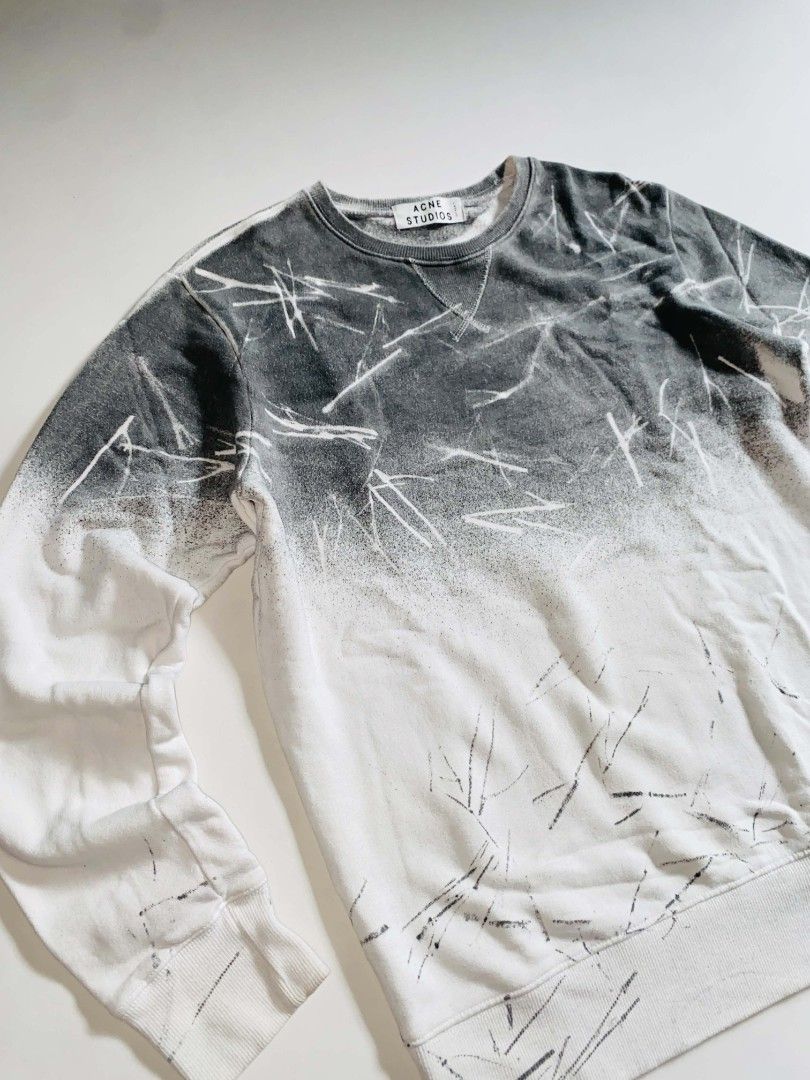 Acne Studios Gradient Spray Paint Sweatshirt (Category: Coats, Jackets and Outerwear) located in Tacurong. Submitted by jeype_ (Listing ID 1467612688, Image 2). Description: - Brand: Acne Studios -Authentic/Legit - Design: Grey and white gradient bleach splatter effect with V-stitch neckline - Material: Soft and cozy cotton fleece - Measurements: Chest width ~20.5-21", Length ~27" - Details: Ribbed collar, cuffs, and hem; clean interior and neck 