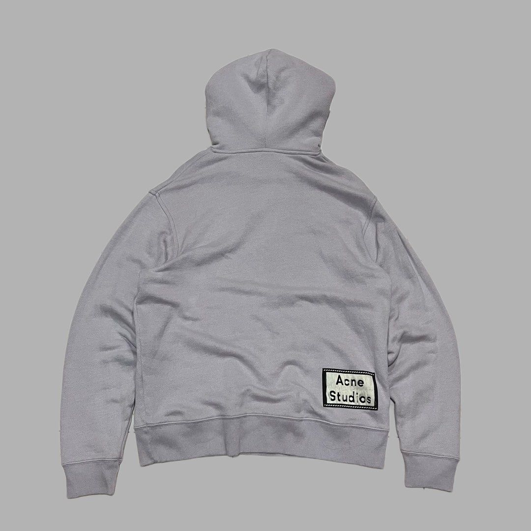 Acne Studios Grey Hoodie with Back Patch Logo (Category: Hoodies) located in Manila. Submitted by frenzyyyy (Listing ID 1467627354, Image 2). Description: - Brand: Acne Studios - Size: Large - Dimes: 24.5/29.5 - Material: Premium heavyweight cotton fleece - Condition: Lightly worn, excellent overall - Features: Drawstring hood, front kangaroo pocket, signature Acne Studios logo patch on the lower back hem - Fit: Comfortable, relaxed fit.