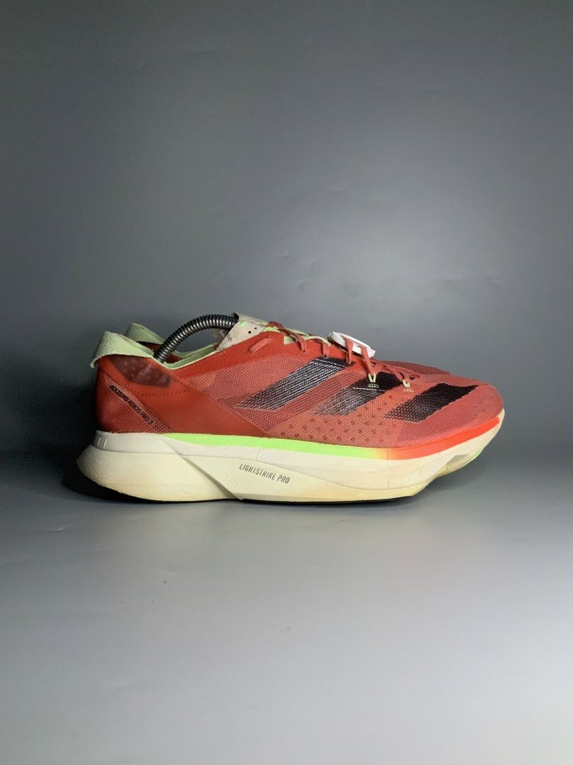 Adidas Adizero Adios Pro 3 (Category: Sneakers) located in Cavite. Submitted by kalye_footwear (Listing ID 1467771333, Image 1). Description: - Brand/Model: Adidas Adizero Adios Pro 3 - Us 10.5 , Euro 44.5 , Cm 28.5 - Colorway: Solar red upper with black three stripes and lime green accents - Technology: Lightstrike Pro cushioning foam for elite energy return - Purpose: High-performance marathon racers built for speed - Condition: Moderate wear o
