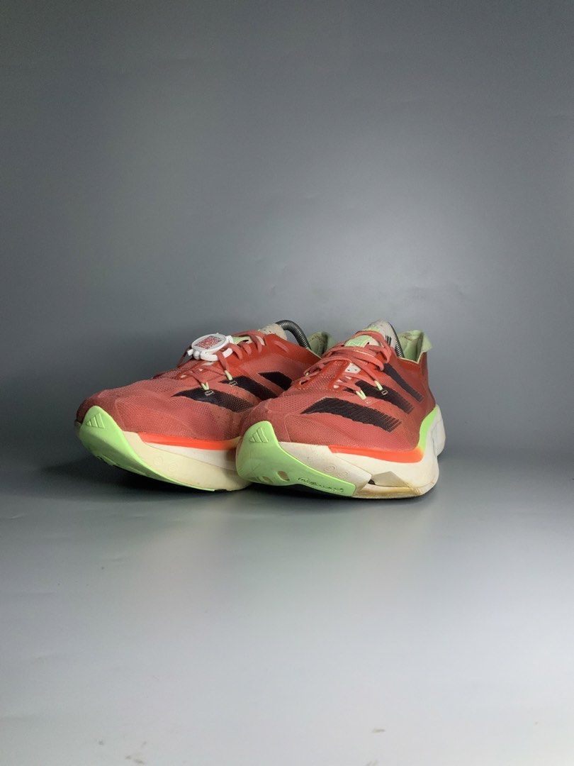 Adidas Adizero Adios Pro 3 (Category: Sneakers) located in Cavite. Submitted by kalye_footwear (Listing ID 1467771333, Image 3). Description: - Brand/Model: Adidas Adizero Adios Pro 3 - Us 10.5 , Euro 44.5 , Cm 28.5 - Colorway: Solar red upper with black three stripes and lime green accents - Technology: Lightstrike Pro cushioning foam for elite energy return - Purpose: High-performance marathon racers built for speed - Condition: Moderate wear o