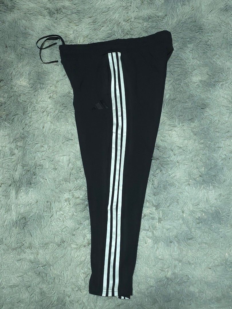 Adidas Black Track Pants with White Stripes (Category: Joggers) located in Abulug. Submitted by humanwhosellthings (Listing ID 1467636687, Image 3). Description: ADI Jogger Pants ✅Excellent Condition ✅Issue: none ▫️Waist Size: 30-36 ▫️Length: 32 - Color: Classic black with bold white side stripes - Branding: Subtle black Adidas logo embroidery near the pocket - Fit: Secure drawstring waist for adjustable comfort - Storage: Convenient zip pockets 