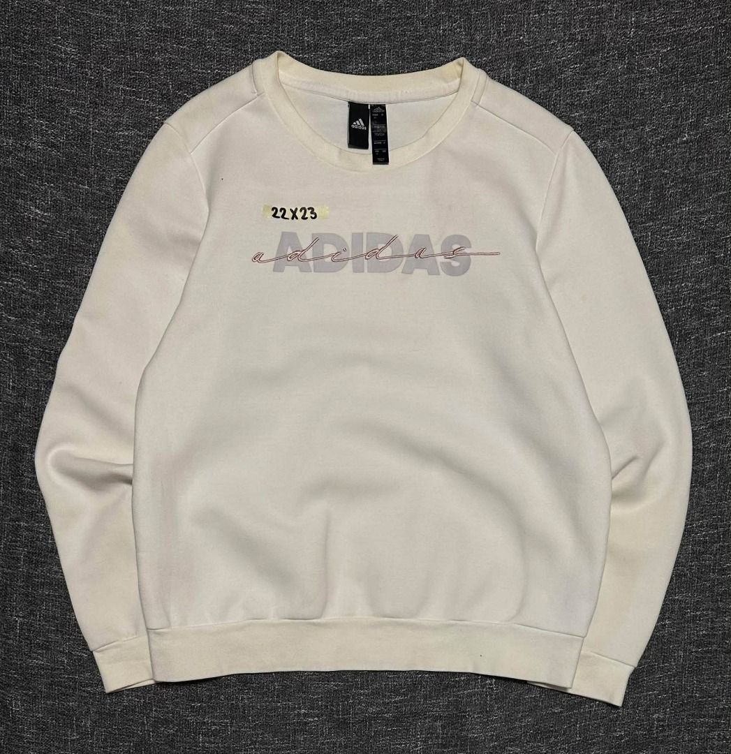 Adidas cream-colored crewneck sweatshirt (Category: Coats, Jackets and Outerwear) located in Manila. Submitted by thriftedbykab (Listing ID 1467718852, Image 1). Description: -Brand: ADIDAS -COMPLETE TAGS -Size: (M) -Width: 22 | Length: 23 -Condition: AS NEW -Color Rate:9.8/10 -Issue: YELLOW STAIN.