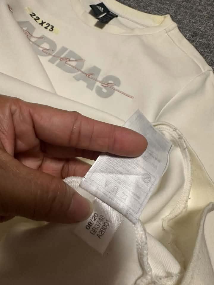 Adidas cream-colored crewneck sweatshirt (Category: Coats, Jackets and Outerwear) located in Manila. Submitted by thriftedbykab (Listing ID 1467718852, Image 2). Description: -Brand: ADIDAS -COMPLETE TAGS -Size: (M) -Width: 22 | Length: 23 -Condition: AS NEW -Color Rate:9.8/10 -Issue: YELLOW STAIN.