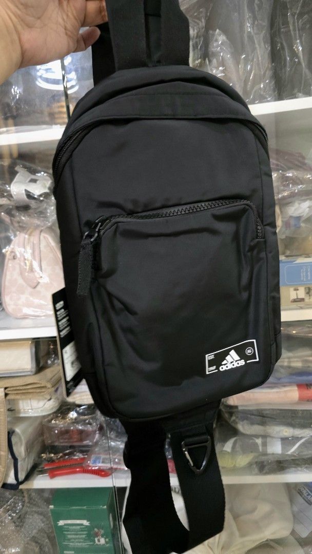 Adidas Essentials Sling Crossbody Bag Black (Category: Sling Bags) located in Quezon City. Submitted by momof3_11 (Listing ID 1467759068, Image 3). Description: - Brand new with original store tags attached - Color: Classic black with crisp white Adidas branding patch - Storage: Secure main zippered compartment and front zip pocket - Hardware: Durable adjustable strap - Size: Compact everyday carry, ideal for phone, wallet, and keys.