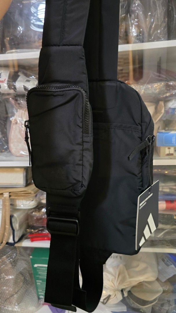 Adidas Essentials Sling Crossbody Bag Black (Category: Sling Bags) located in Quezon City. Submitted by momof3_11 (Listing ID 1467759068, Image 2). Description: - Brand new with original store tags attached - Color: Classic black with crisp white Adidas branding patch - Storage: Secure main zippered compartment and front zip pocket - Hardware: Durable adjustable strap - Size: Compact everyday carry, ideal for phone, wallet, and keys.