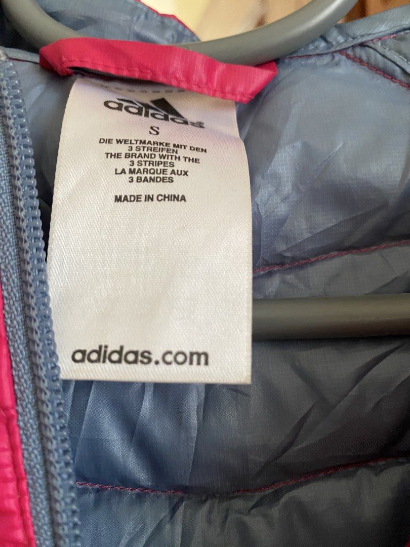 Adidas Pink Puffer Jacket Size S (Category: Coats, Jackets and Outerwear) located in Manila. Submitted by freestone_f18729 (Listing ID 1467617133, Image 3). Description: - Brand: Adidas - Color: Bright pink with grey lining - Size: Small - Lightweight yet warm winter jacket - Zip-up front with secure zipped pockets on both sides - Attached hood with adjustable toggle cord - Elastic cuffs to keep the wind out - Condition: Clean and well-maintained