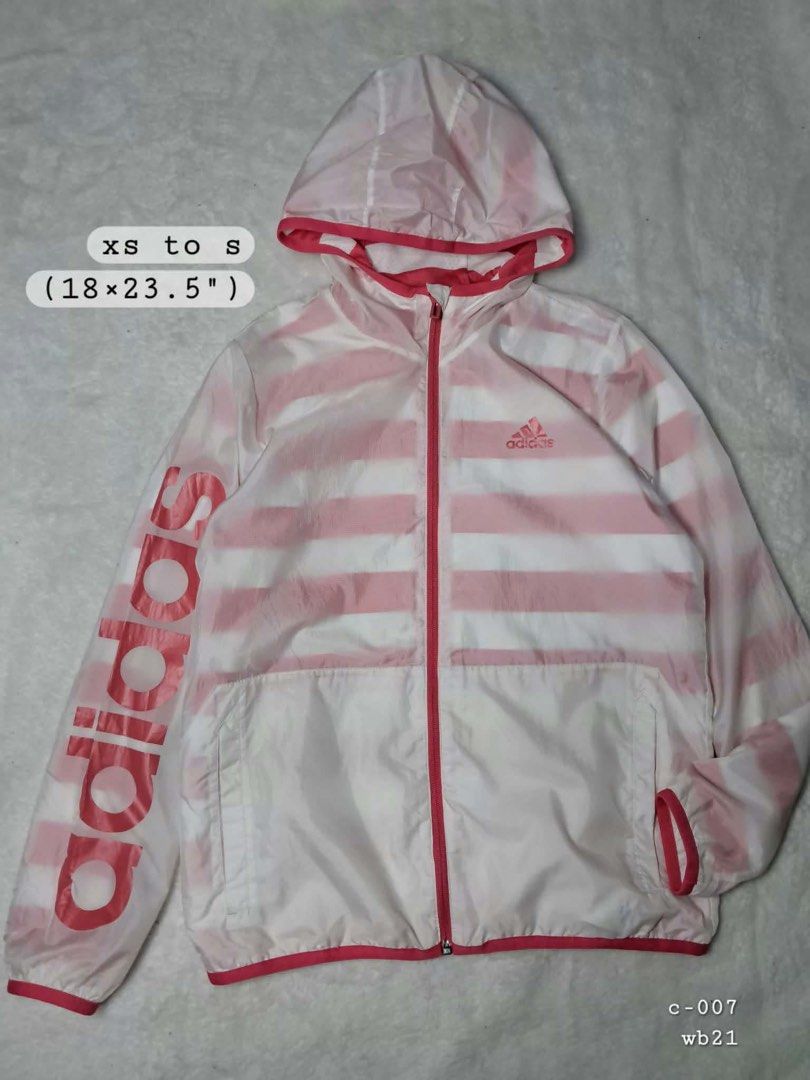 Adidas reversible Pink White Striped windbreaker Jacket (Category: Coats, Jackets and Outerwear) located in Baguio. Submitted by padisellsz (Listing ID 1467729031, Image 1). Description: - Brand: Adidas - Very good condition - slight stain washable - Color: Pink with white stripes - Size: 152 / fits XS to S (18" x 23.5" flat lay measurements) - Features: Full zip closure, attached hood, and large Adidas logo printed down the right sleeve - Materi