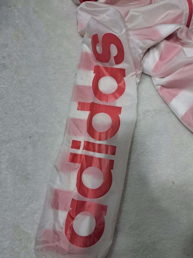 Adidas reversible Pink White Striped windbreaker Jacket (Category: Coats, Jackets and Outerwear) located in Baguio. Submitted by padisellsz (Listing ID 1467729031, Image 3). Description: - Brand: Adidas - Very good condition - slight stain washable - Color: Pink with white stripes - Size: 152 / fits XS to S (18" x 23.5" flat lay measurements) - Features: Full zip closure, attached hood, and large Adidas logo printed down the right sleeve - Materi