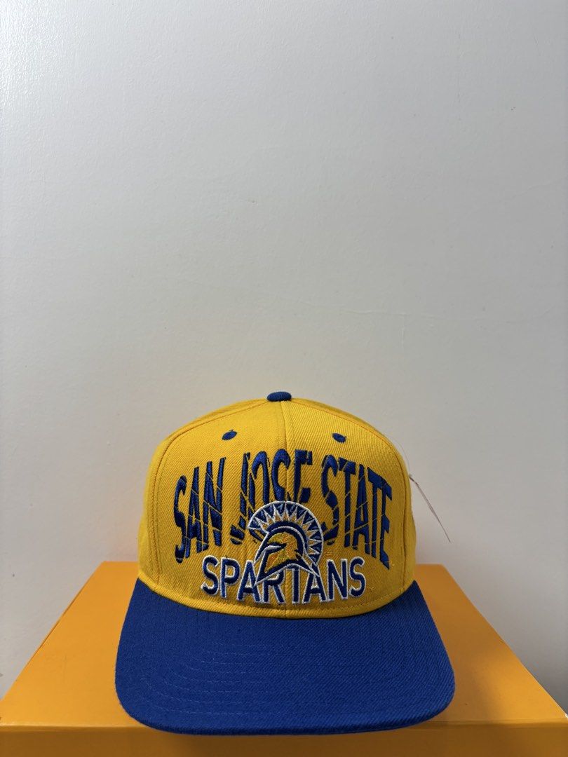 Adidas San Jose State Spartans Snapback Hat (Category: Caps & Hats) located in Marikina City. Submitted by zaxcheus_castillo1708 (Listing ID 1467654456, Image 1). Description: - Brand: Adidas - Team: San Jose State Spartans - Design: Yellow cap with blue brim, top button, and adjustable snap closure - Details: Large team embroidery on front, white Adidas trefoil logo on back - Material: 80% acrylic, 20% wool blend - Origin: Made in Bangladesh - S
