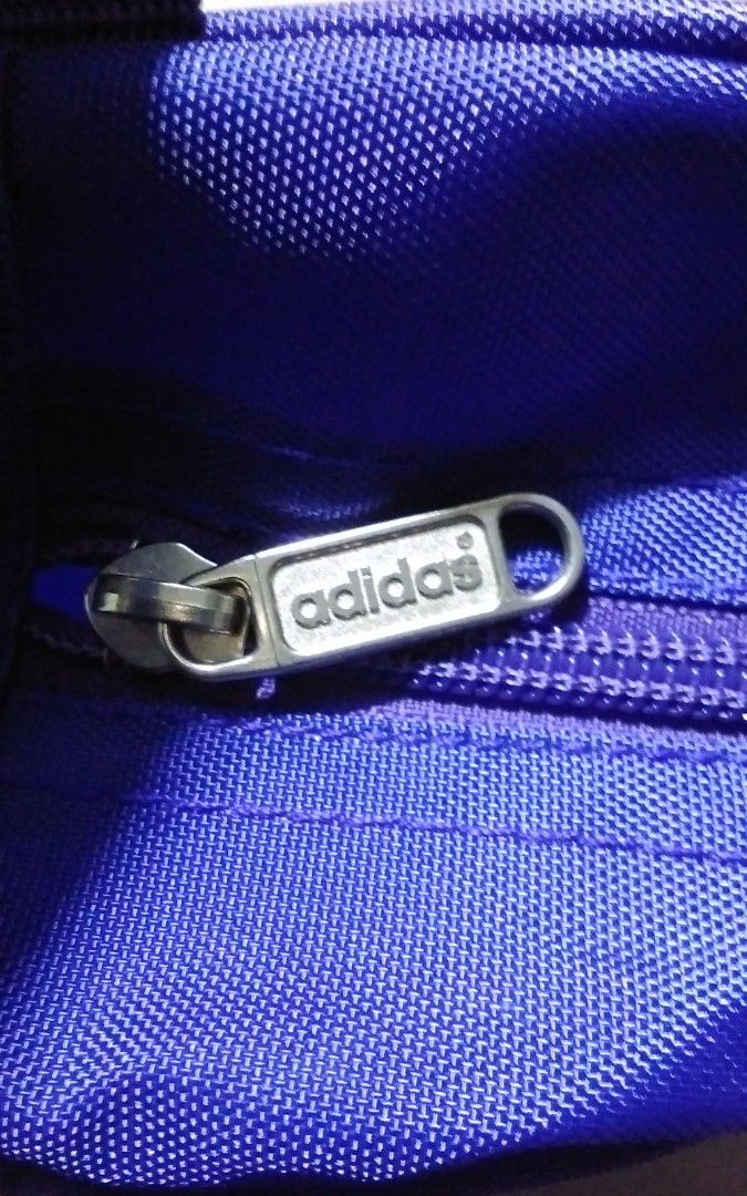 Adidas shoe bags (Category: Announcements) located in Quezon City. Submitted by Bernz (Listing ID 1467723857, Image 3). Description: This is a vintage Adidas Originals shoe bag (or boot bag) featuring a retro "The Team" design. Key Features Design Elements: It displays the classic Trefoil logo, the slogan "Die Weltmarke mit den drei Streifen" (The brand with the three stripes), and text reading "THE TEAM" running vertically along the front.Functi