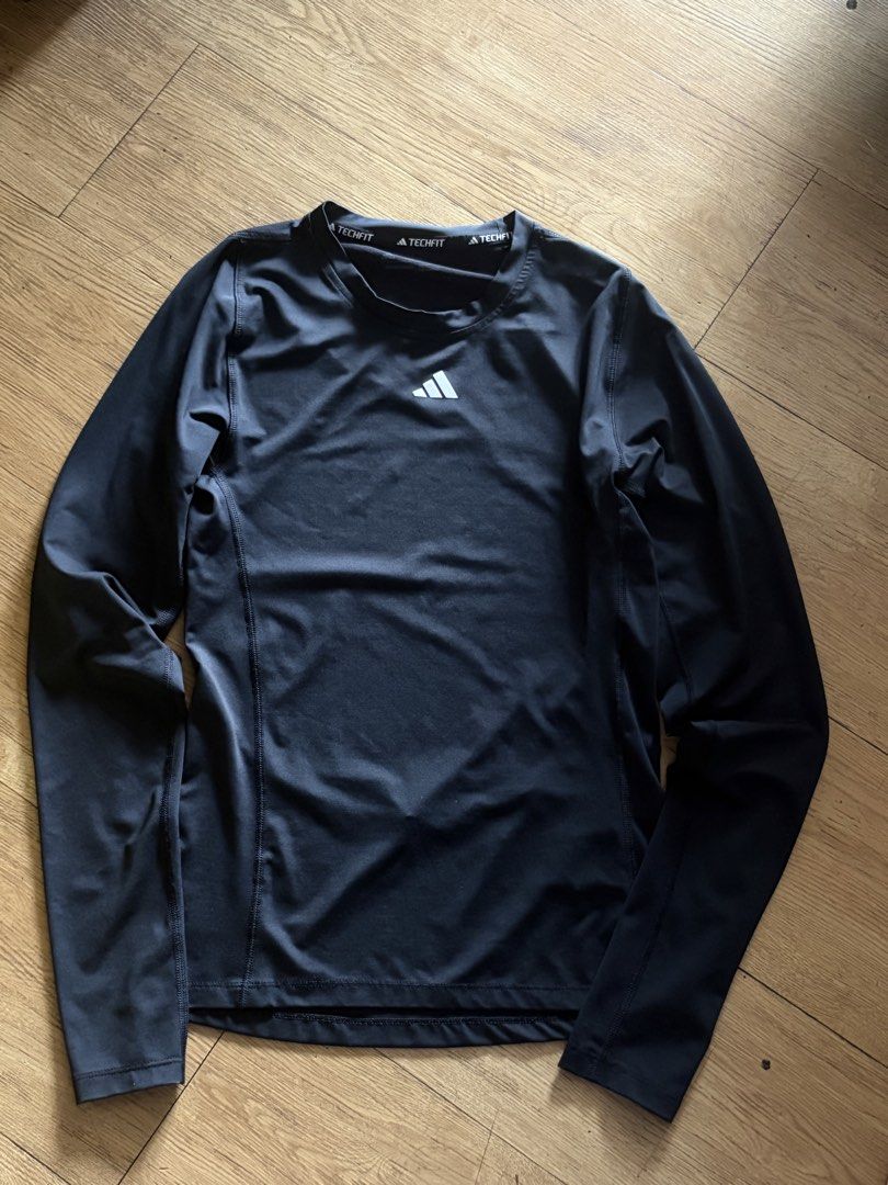 Adidas Techfit Black Long Sleeve Compression Shirt (Category: Activewear) located in Taguig. Submitted by wornbyjmag (Listing ID 1467608635, Image 1). Description: - Brand: Adidas - Style: Techfit long sleeve compression shirt - Color: Black with white Adidas performance logo - Neckline: Crew neck with ribbed trim and Techfit collar tape - Fit: Form-fitting - Ideal for: Workouts, gym sessions, or layering under jerseys.