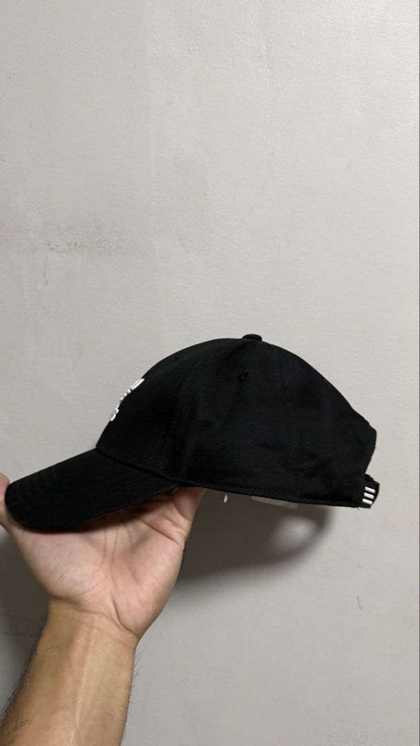 Adidas Trefoil Black Baseball Cap (Category: Caps & Hats) located in Quezon City. Submitted by kobeeeee_12 (Listing ID 1467738440, Image 3). Description: - Brand: Adidas - Color: Classic black with white embroidered Trefoil logo - Material: 100% cotton main with polyester blend lining - Size: OSFM (One Size Fits Most), adjustable strap with metal buckle - Features: Signature three stripes accent, classic curved brim, and branded inner taping - Co