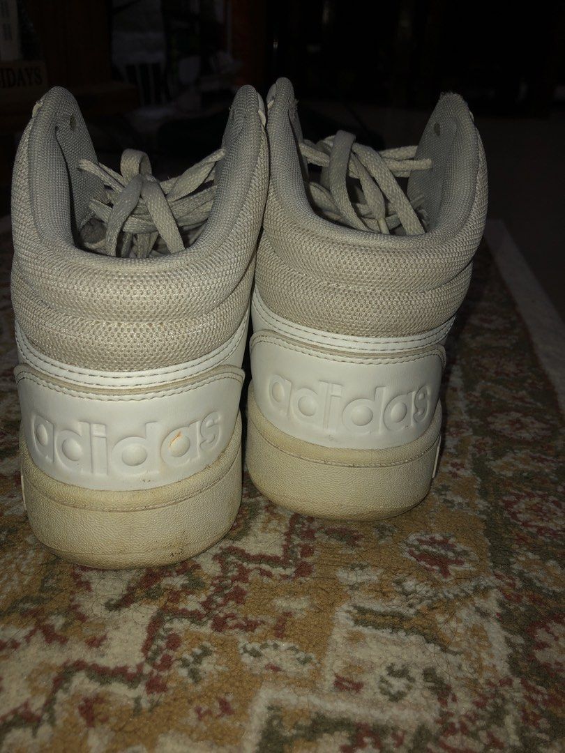 Adidas White High-Top Sneakers (Category: Sneakers) located in Bacoor. Submitted by meann.sy (Listing ID 1467761281, Image 2). Description: - Authentic white adidas high-top sneakers - Secure lace-up closure with a comfortable padded ankle collar - Classic perforated details on the toe box - Subtle debossed adidas logo on the heel counter - Clean laces included - Soles show minor wear and slight discoloration from regular use.