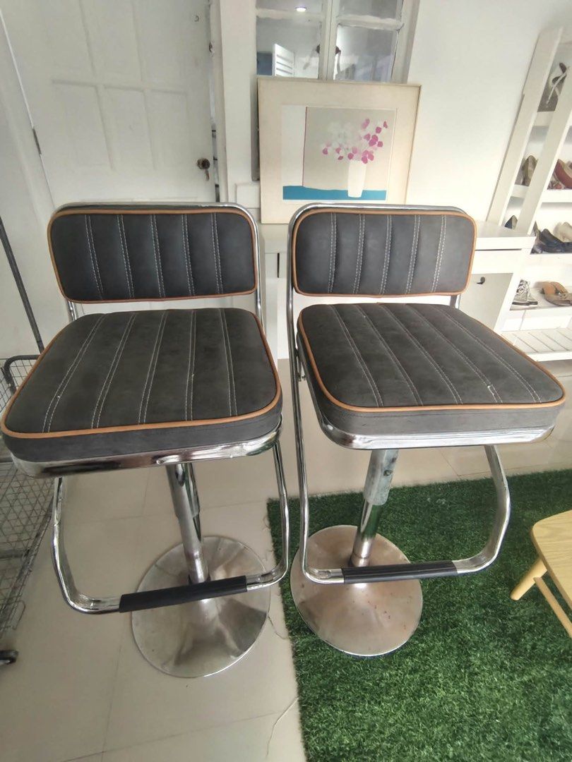 Adjustable Bar Stools Grey and Chrome Pair (Category: Chairs) located in Taguig. Submitted by elealehcapco (Listing ID 1467741960, Image 1). Description: - Set of 2 adjustable bar stools - Grey upholstered seats and backrests with stylish tan piping - Vertical channel tufting design for a modern look - Shiny chrome metal pedestal bases with convenient footrests - Smooth gas lift mechanism for easy height adjustment - Minor scuffs on the chrome ba