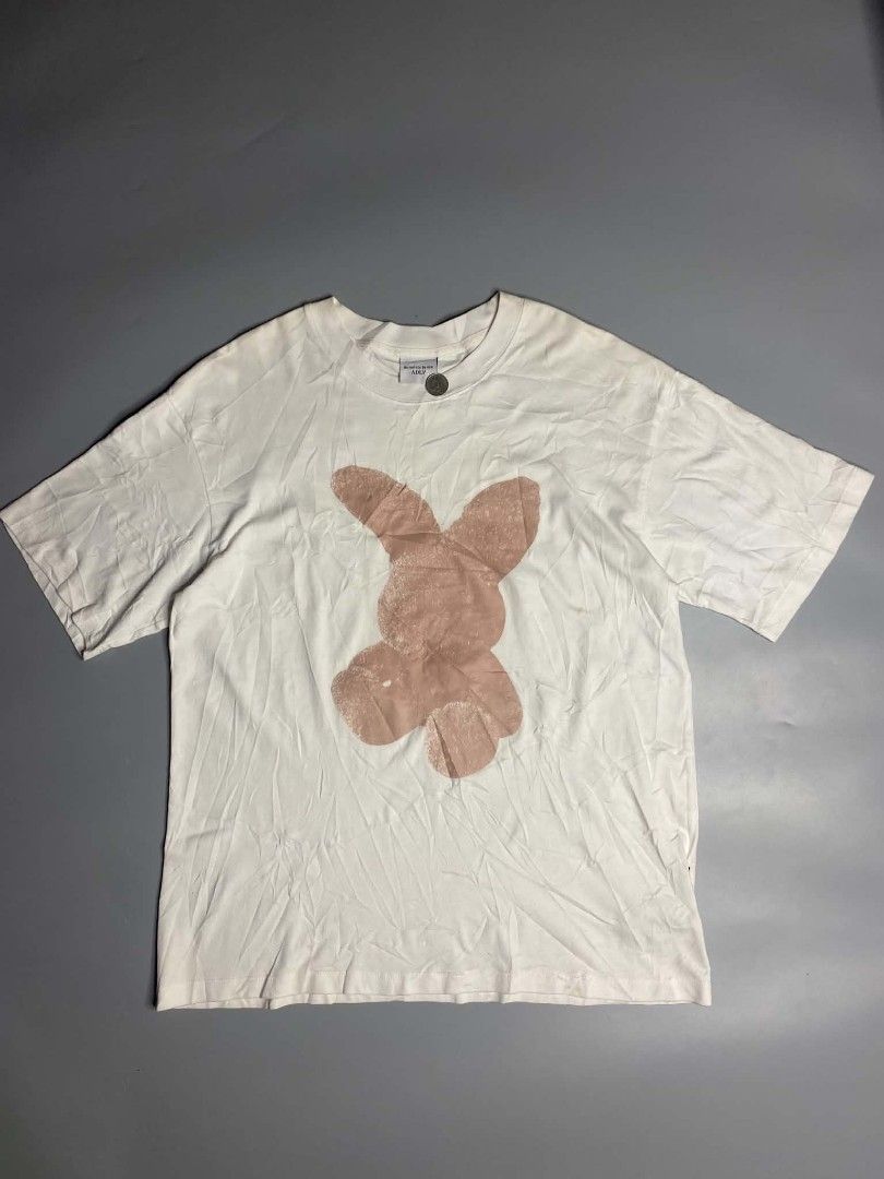 ADLV White Graphic T-Shirt Size 1 (Category: Tshirts & Polo Shirts ) located in Ajuy. Submitted by quickcrystal-effaca (Listing ID 1467681708, Image 1). Description: - Brand: Acmé De La Vie (ADLV) - Color: Crisp White - Design: Large pink bunny graphic on the front - Style: Short sleeves, crew neck - Size: Size 1 (ADLV standard sizing) - Details: Official website URL printed on the back collar tag - Condition: Excellent, clean fabric with minimal