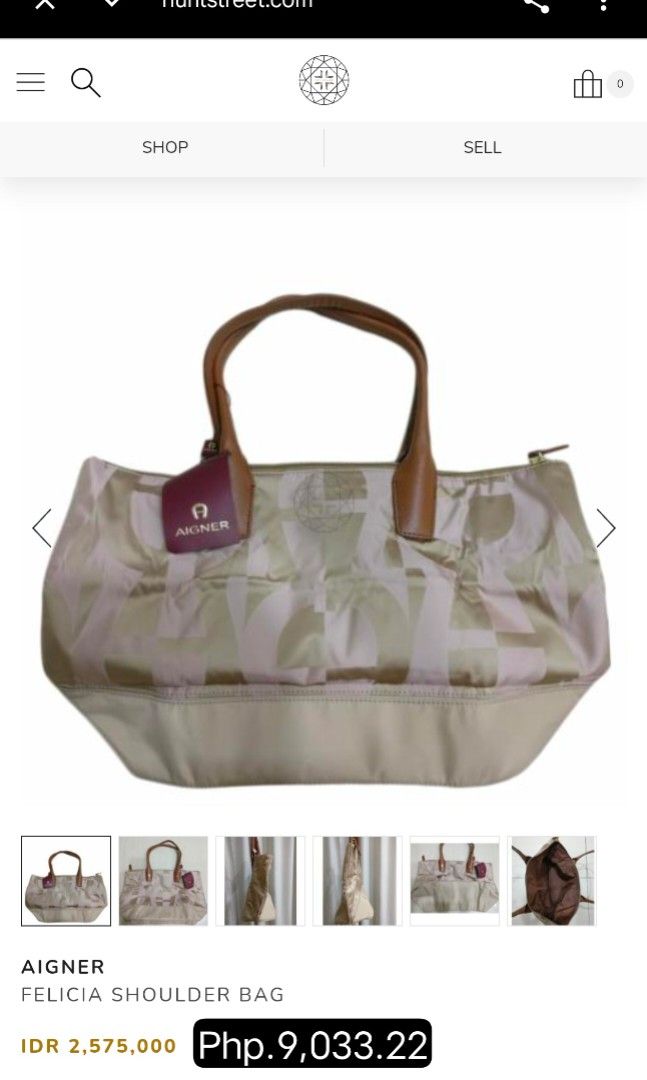 Aigner Vintage Monogram Classic Tote Bag (Category: Tote Bags) located in Baguio. Submitted by PreiLoveMaria (Listing ID 1467761828, Image 3). Description: Aigner tote bag featuring the brand's signature monogram/logo pattern across a durable olive/khaki-toned fabric body, complemented by light beige/cream leather trim and dual top handles. ​Branded with the iconic Aigner logo hardware on the interior leather patch, which also reads "MADE IN ITAL