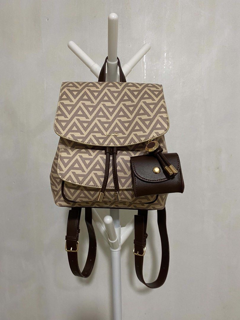 ALDO Miniella Backpack (Category: Backpacks) located in La Paz. Submitted by itsmejc_0714 (Listing ID 1467702195, Image 2). Description: An all-over geometric ALDO monogram print in beige/tan, a drawstring main compartment under a top flap, and comes with a signature detachable matching coin purse / pouch..