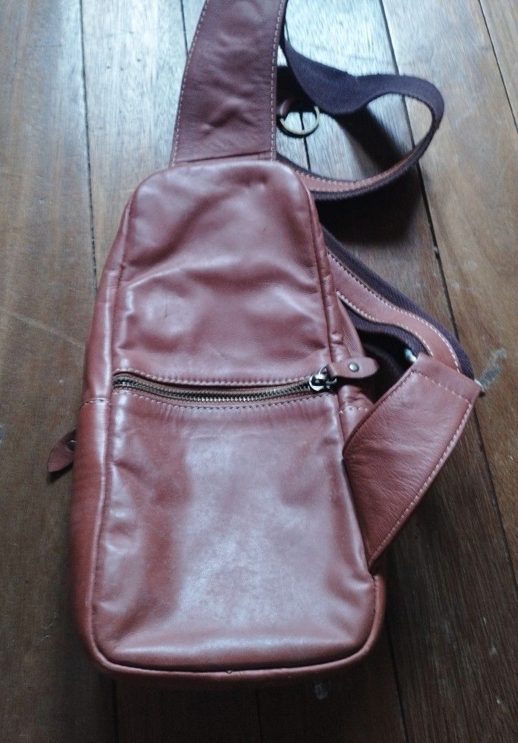 Alfa Est. 1987 Leather Sling Bag Brown (Category: Sling Bags) located in Baguio. Submitted by katgon2016 (Listing ID 1467680375, Image 3). Description: - Brand: Alfa Est. 1987 - Material: Genuine brown leather with fabric strap and vintage-finish hardware - Storage: Main zippered compartment and convenient front zippered pocket - Interior: Includes an extra zippered pocket and official Alfa leather patch tag - Comfort: Adjustable fabric strap wit