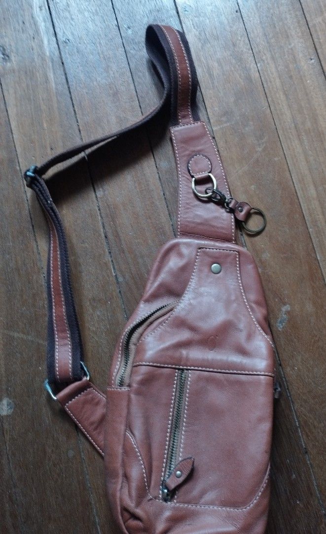 Alfa Est. 1987 Leather Sling Bag Brown (Category: Sling Bags) located in Baguio. Submitted by katgon2016 (Listing ID 1467680375, Image 1). Description: - Brand: Alfa Est. 1987 - Material: Genuine brown leather with fabric strap and vintage-finish hardware - Storage: Main zippered compartment and convenient front zippered pocket - Interior: Includes an extra zippered pocket and official Alfa leather patch tag - Comfort: Adjustable fabric strap wit