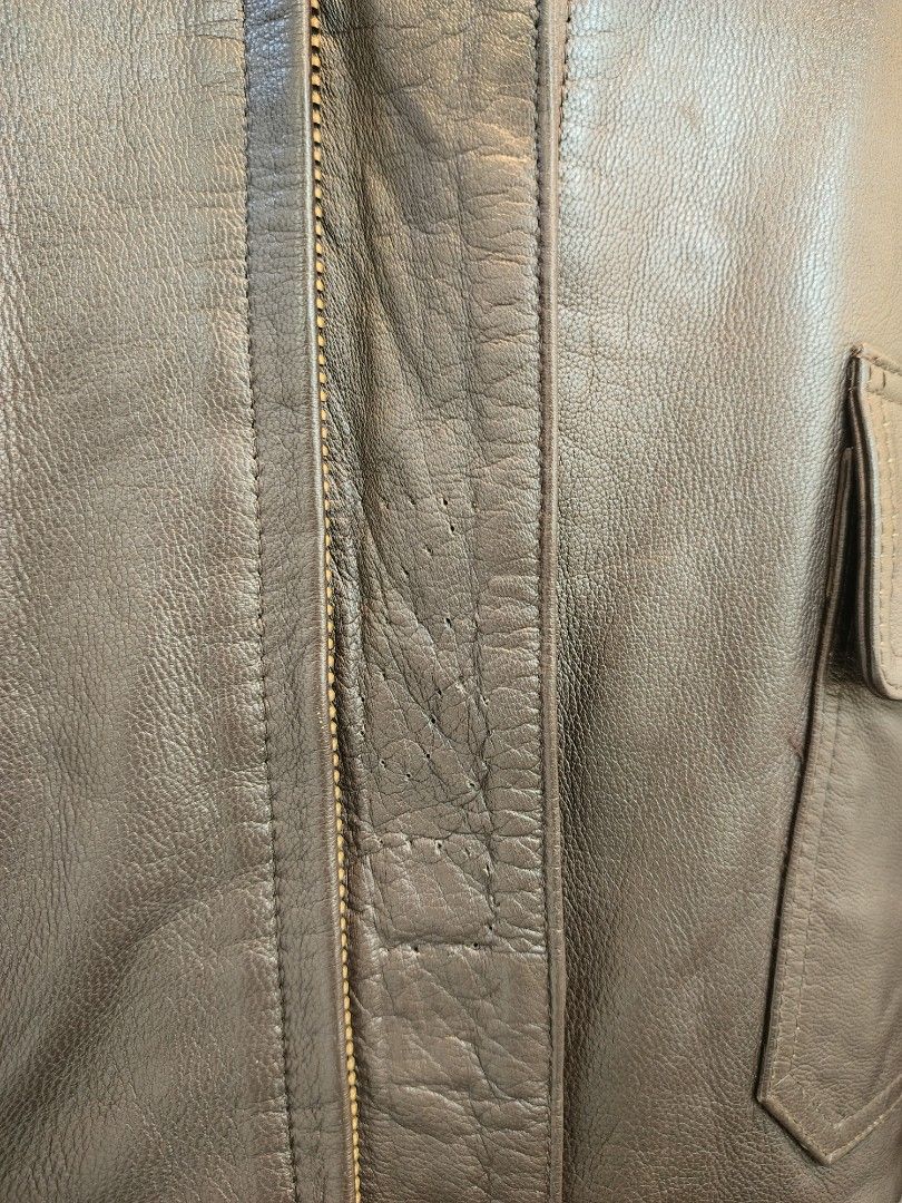 Alpha Industries USN Brown Leather Bomber Jacket (Category: Coats, Jackets and Outerwear) located in La Trinidad. Submitted by padasem_kadi (Listing ID 1467645160, Image 2). Description: - Classic brown leather bomber jacket with a cozy dark brown faux fur collar - Wind-blocking ribbed cuffs and hem for extra warmth - Two front flap pockets with secure button closures and heavy-duty front zip - Measurements: Chest 25", Length 26", Sleeves 26" - C