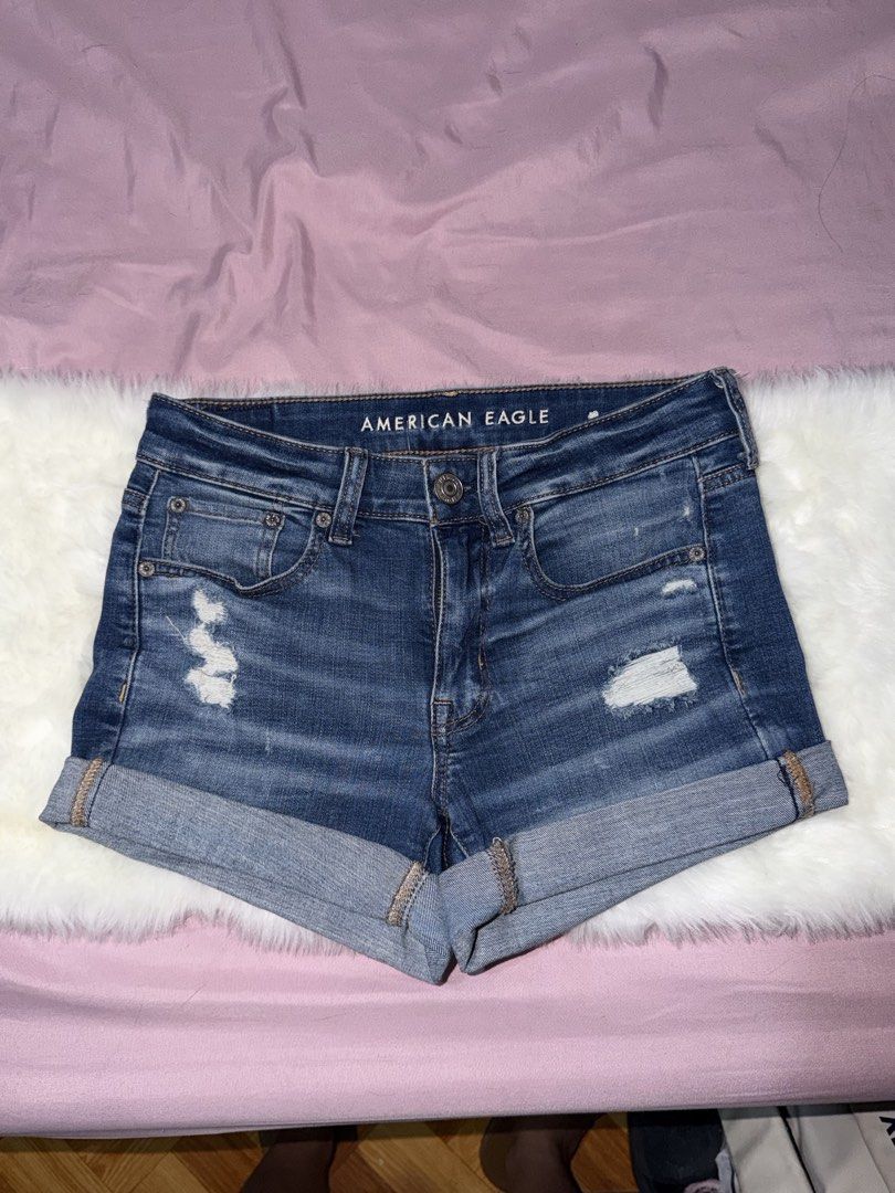 American Eagle Ripped Denim Shorts Rolled Cuff (Category: Shorts) located in Manila. Submitted by maureenn10 (Listing ID 1467790921, Image 1). Description: - Brand: American Eagle - Color/Wash: Dark blue - Fit: Mid-rise with cuffed hems - Details: Distressed front and back pocket, 5-pocket styling, metal button closure, branded leather patch - Condition: Great pre-loved staple for hot weather.