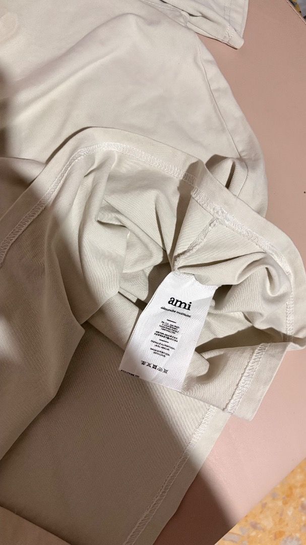 Ami Paris T-Shirt Off White Embossed Logo (Category: Tshirts & Polo Shirts ) located in Molave. Submitted by shoethriftengs (Listing ID 1467701954, Image 3). Description: - Brand: Ami Paris - Color: Off-white - Material: 100% comfortable cotton - Design: Embossed logo on front chest with small embroidered Ami lettering near the back neckline - Fit: Classic crew neck and short sleeves - Condition: Excellent, comes with original inside branding and