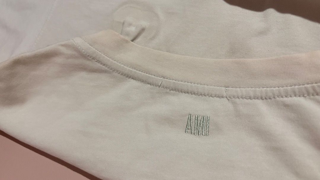 Ami Paris T-Shirt Off White Embossed Logo (Category: Tshirts & Polo Shirts ) located in Molave. Submitted by shoethriftengs (Listing ID 1467701954, Image 2). Description: - Brand: Ami Paris - Color: Off-white - Material: 100% comfortable cotton - Design: Embossed logo on front chest with small embroidered Ami lettering near the back neckline - Fit: Classic crew neck and short sleeves - Condition: Excellent, comes with original inside branding and