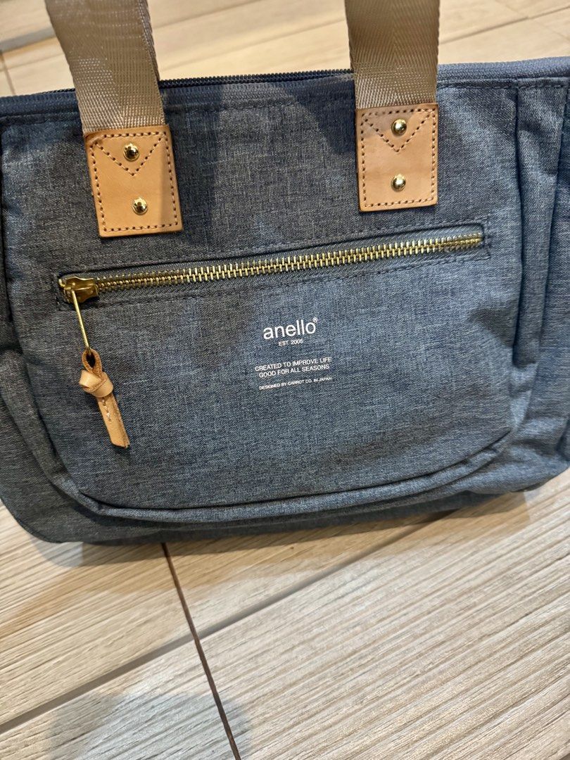 Anello Denim Tote Bag with Shoulder Strap (Category: Tote Bags) located in Valenzuela. Submitted by thecozyclosetph (Listing ID 1467634243, Image 3). Description: - Brand: anello - Material: Blue denim with beige handles and gold hardware - Pockets: Front zipper pocket and internal slip pockets - Strap: Includes a detachable shoulder strap with metal clasps - Condition: Clean interior and exterior, ready to use.