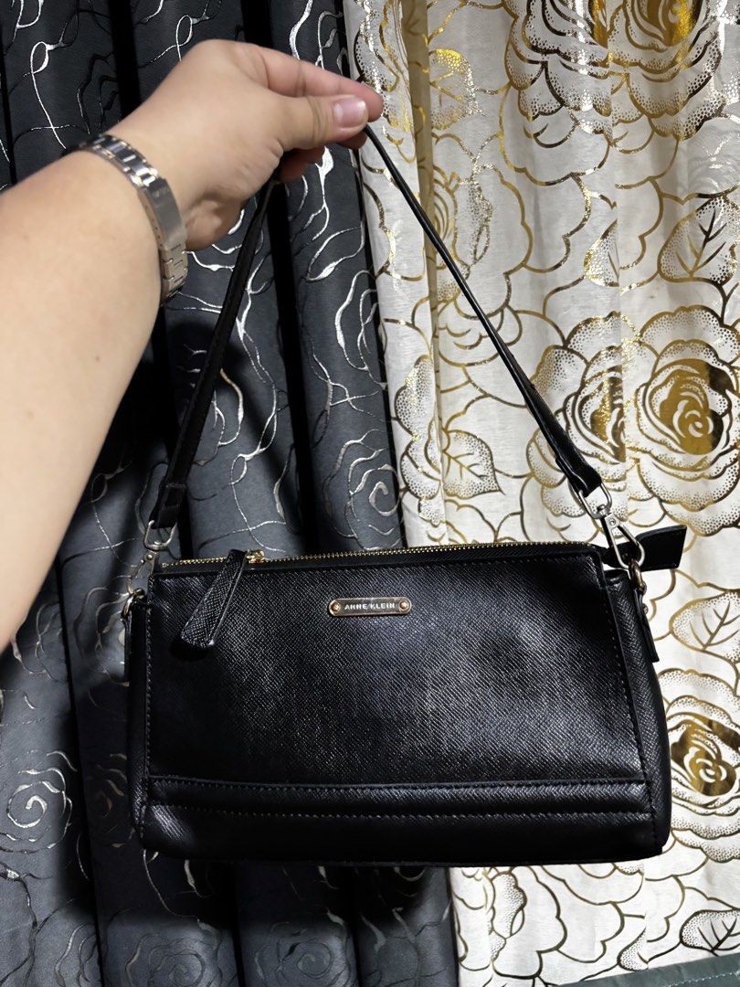 Anne Klein Black Shoulder Bag (Category: Shoulder Bags) located in Cagayan de Oro. Submitted by erica2000 (Listing ID 1467701634, Image 1). Description: - Brand: Anne Klein - Color: Classic Black - Material: Saffiano texture finish with luxurious gold hardware - Closure: Secure top zipper - Pockets: Exterior back zip pocket and interior zip pocket with Anne Klein logo patch - Interior: Fully lined with durable black fabric - Strap: Slim, detachab
