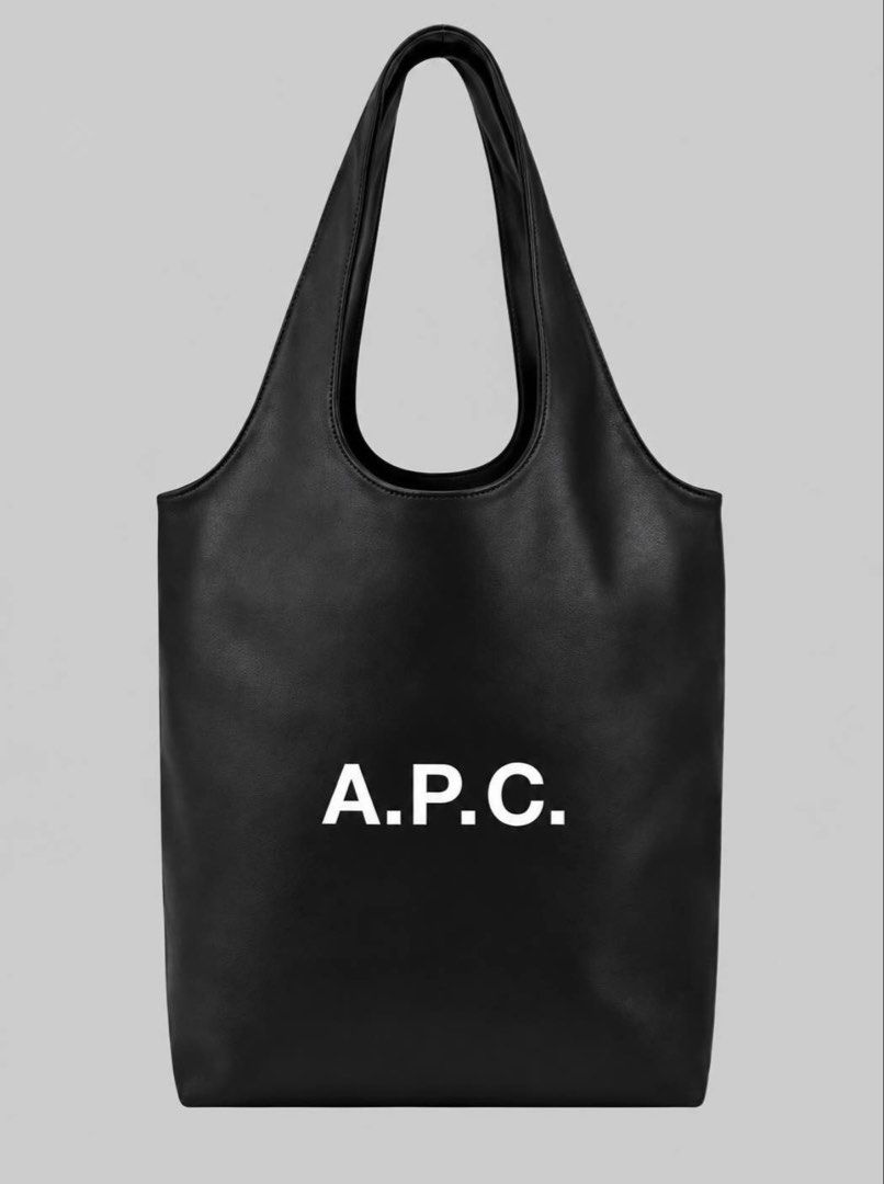 A.P.C. Leather Tote Bag (Category: Tote Bags) located in Mabalacat. Submitted by davidbianc04942 (Listing ID 1467731477, Image 1). Description: - Brand: A.P.C. - Style: Minimalist leather tote bag with a clean silhouette - Design: Bold white logo lettering centered on the front - Features: Double shoulder straps and a spacious interior for daily essentials - Colors available: Black, tan, and off-white - Material/Finish: Smooth finish.