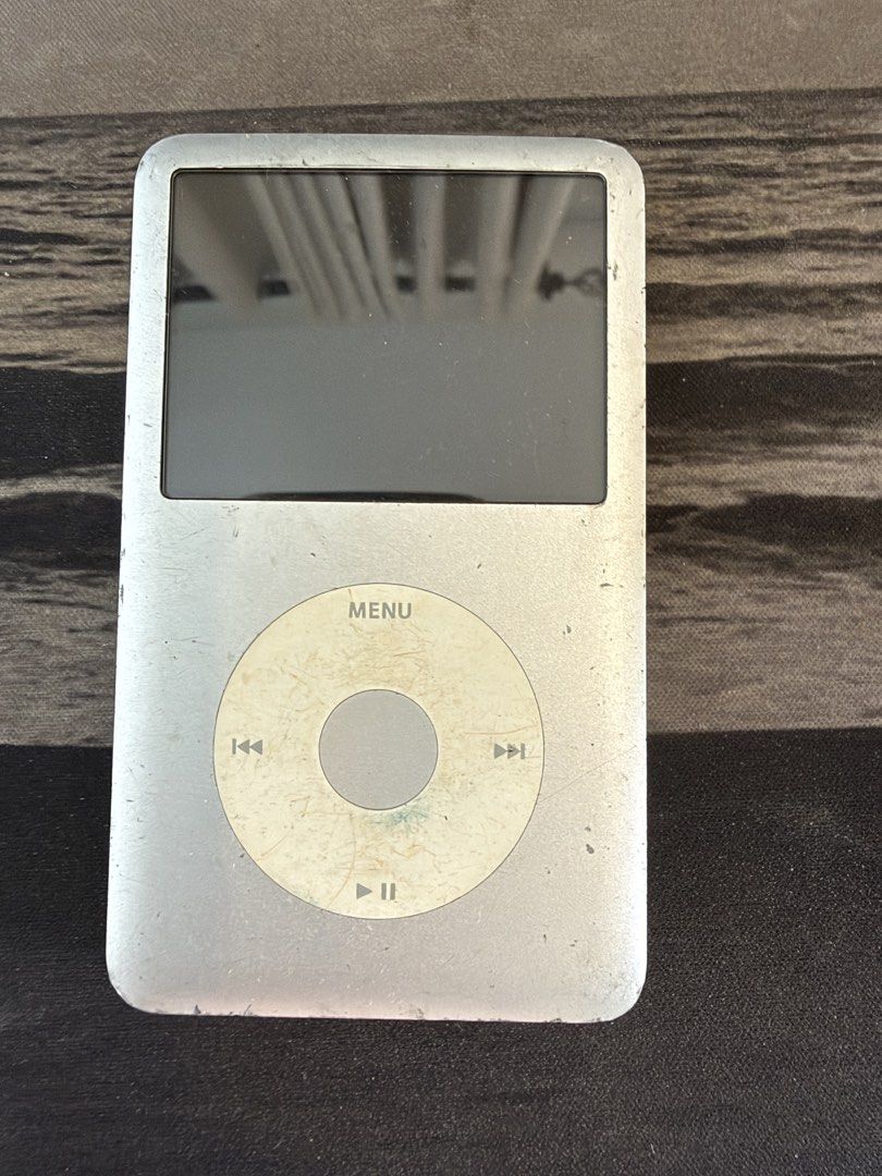 Apple iPod Classic 6th Gen 80GB Silver (Category: Portable Music Players) located in Makati City. Submitted by dennis_dumlao (Listing ID 1467622449, Image 1). Description: - Model: Apple iPod Classic 80GB - Color: Silver - Serial Number: Q216510CY5N - Features: Iconic click wheel, 30-pin dock connector, top headphone jack, and hold switch - Condition: Heavy cosmetic wear including deep scratches on the front screen and silver back casing - Detail