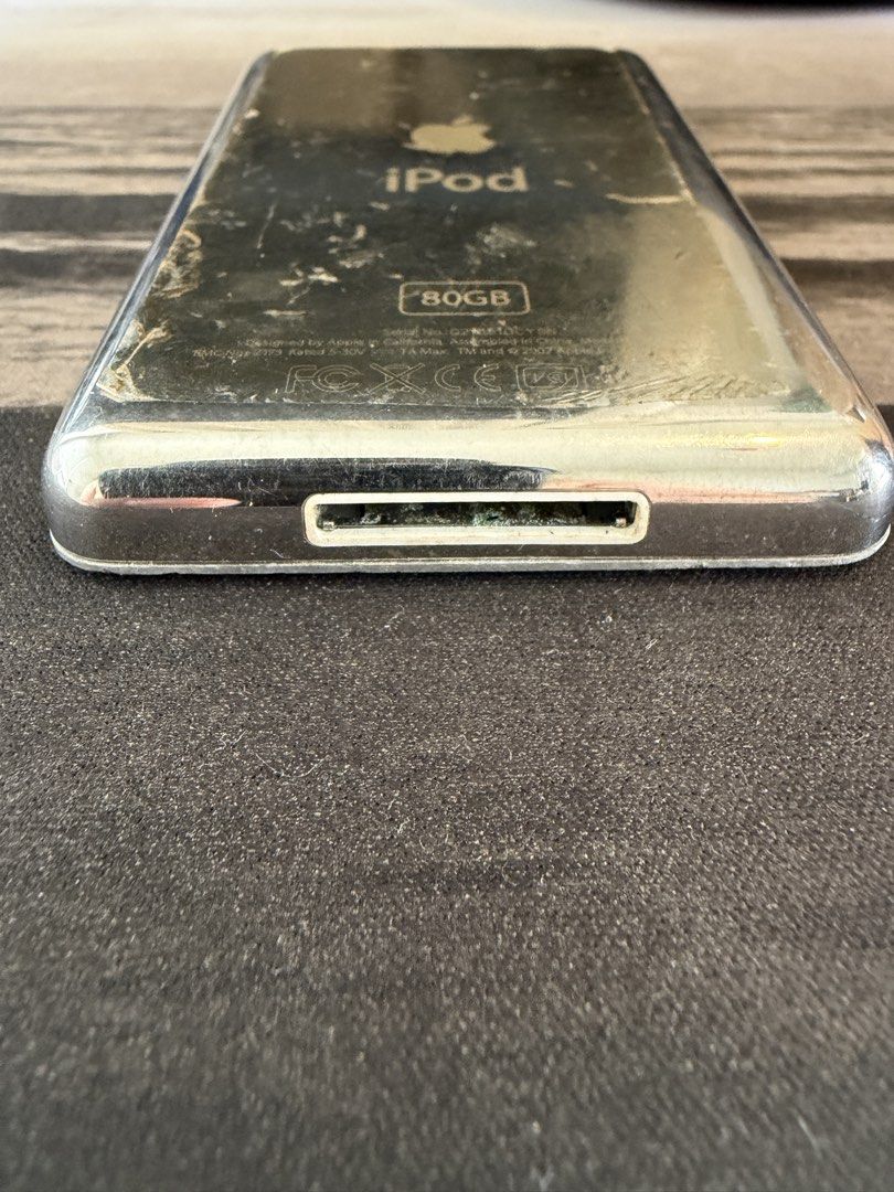 Apple iPod Classic 6th Gen 80GB Silver (Category: Portable Music Players) located in Makati City. Submitted by dennis_dumlao (Listing ID 1467622449, Image 3). Description: - Model: Apple iPod Classic 80GB - Color: Silver - Serial Number: Q216510CY5N - Features: Iconic click wheel, 30-pin dock connector, top headphone jack, and hold switch - Condition: Heavy cosmetic wear including deep scratches on the front screen and silver back casing - Detail