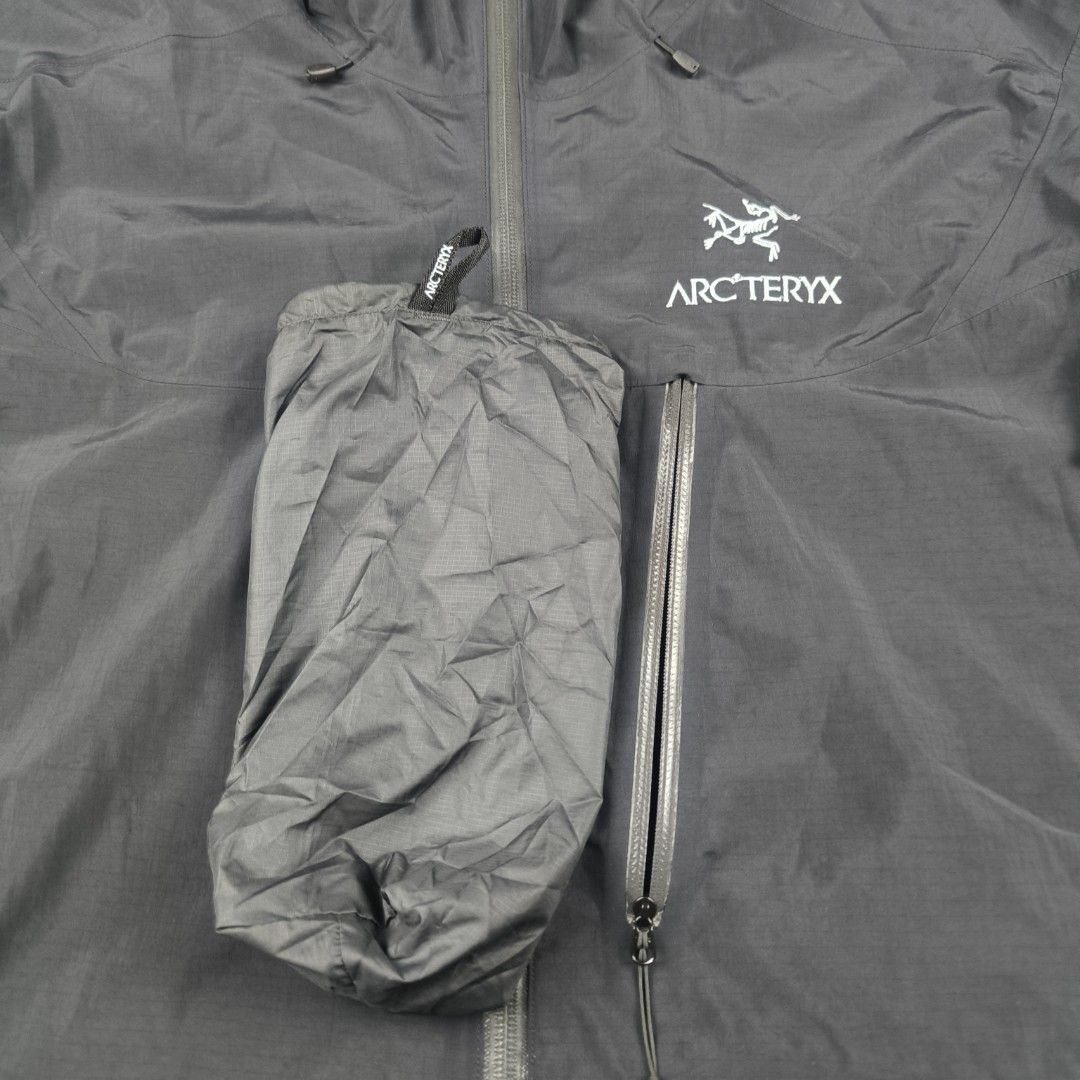 Arc'teryx Alpha SL Jacket (Men's) (Category: Coats, Jackets and Outerwear) located in General Mariano Alvarez. Submitted by rammrtnz (Listing ID 1467791162, Image 3). Description: Arc'teryx Alpha SL Jacket (Men's) Lightweight With pouch (packable) Size M on tag Actual measurement: Width - 23inches Length - 26.7/30inches measured in front laid flat Note: nagstart na magcracks lang sa glue(mostly hood or near sa hood. Okay pa mga seams) Normal sign