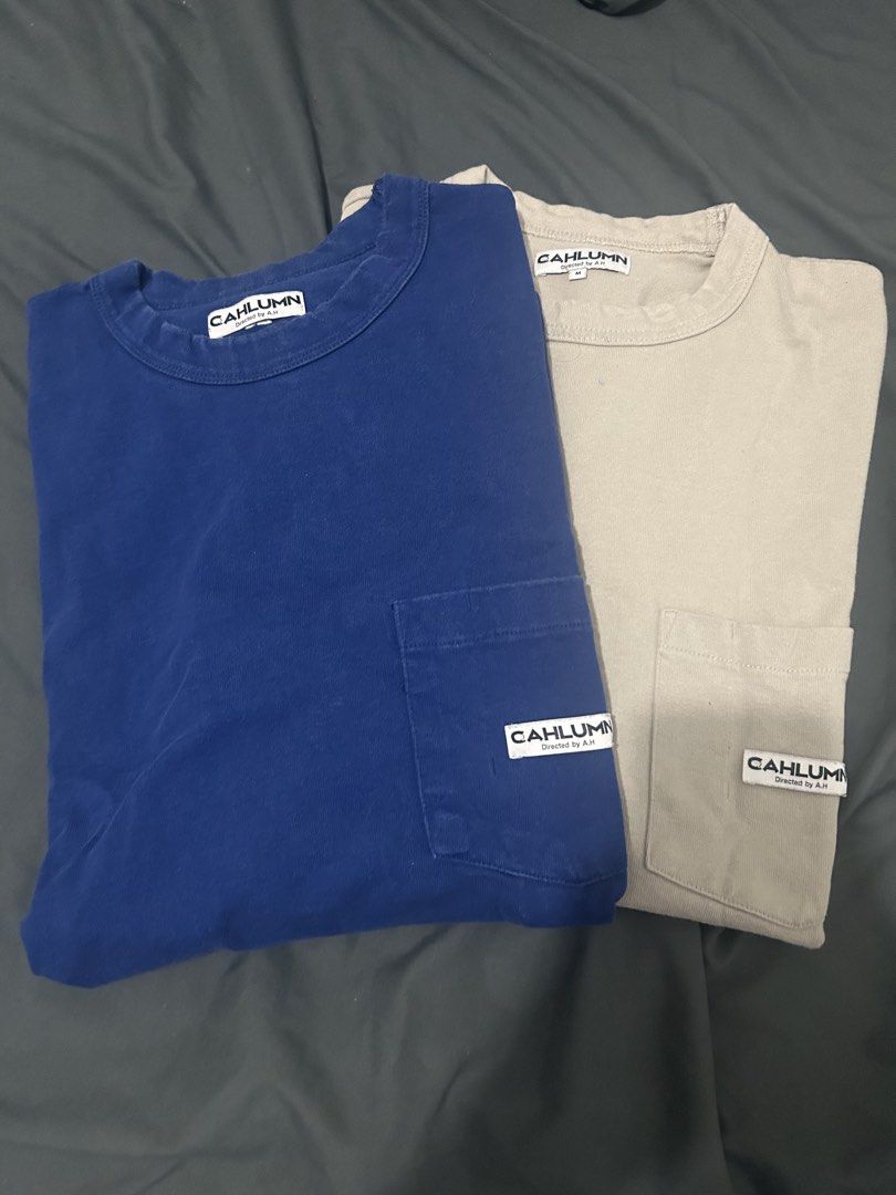 AS PACK! Cahlumn Pocket Tees (Category: Tshirts & Polo Shirts ) located in Lucena. Submitted by cityboyfits (Listing ID 1467837087, Image 1). Description: - Brand: Cahlumn (Directed by A.H.) - Material: 100% Cotton - Colors & Sizes: Blue (Large) and Beige (Medium) - Dimes: 29x25 (Blue), 28x24.5 (Beige) - Details: Chest pocket with Cahlumn brand patch on both - Special Feature: '23 embroidered near the neckline on the blue shirt - Great basic tees