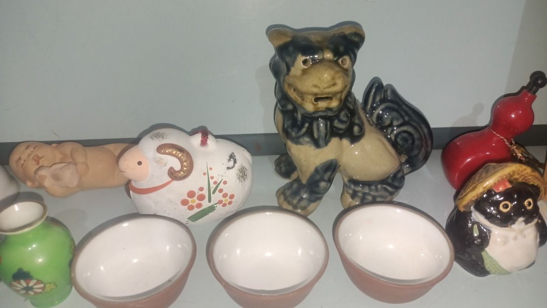 Assorted Japanese Ceramic Ornaments Figures and Tea Set (Category: Vintage Collectibles) located in Munoz. Submitted by larryc1212 (Listing ID 1467681783, Image 3). Description: - Diverse collection of Asian decorative pieces - Includes ceramic guardian lion, sheep, miniature tea cups, and small vases - Features chopstick rests, a wooden Japanese calligraphy plaque, and a retro boxed doll - Made from quality pottery, porcelain, and wood - Perfect