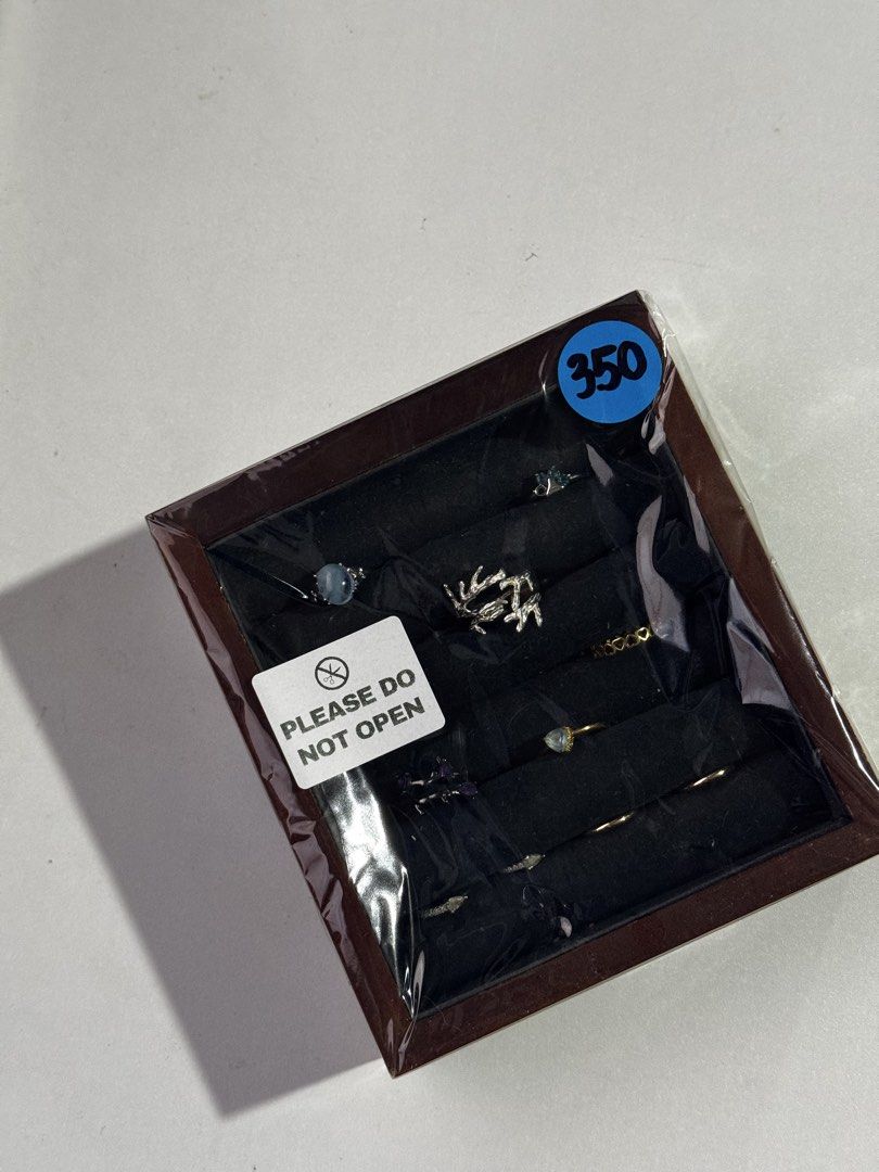 Assorted Rings Set in Wooden Storage Box (Category: Accessory Holder, Box & Organizers) located in Penaranda. Submitted by deardarlaph_ (Listing ID 1467706739, Image 2). Description: - Wooden jewelry box with a stunning collection of multiple rings - Variety of designs: textured bands, gemstone rings, and minimalist styles - Comes in a display tray with velvet slots - Brand new and factory sealed in plastic wrap with 'Please Do Not Open' label - 