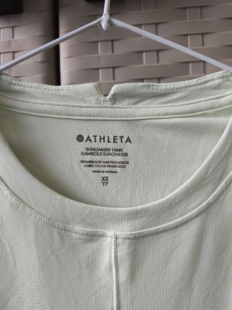 Athleta Sunchaser Tank Top Size XS (Category: Sleeveless) located in Cabanatuan. Submitted by lyxyx (Listing ID 1467713221, Image 2). Description: - Brand: Athleta - Style: Sunchaser tank top - Color: Pale green - Size: XS - Material: Lightweight ribbed texture - Design details: Crew neckline with small collar cutout, center vertical front seam - Origin: Designed in San Francisco, made in Vietnam.