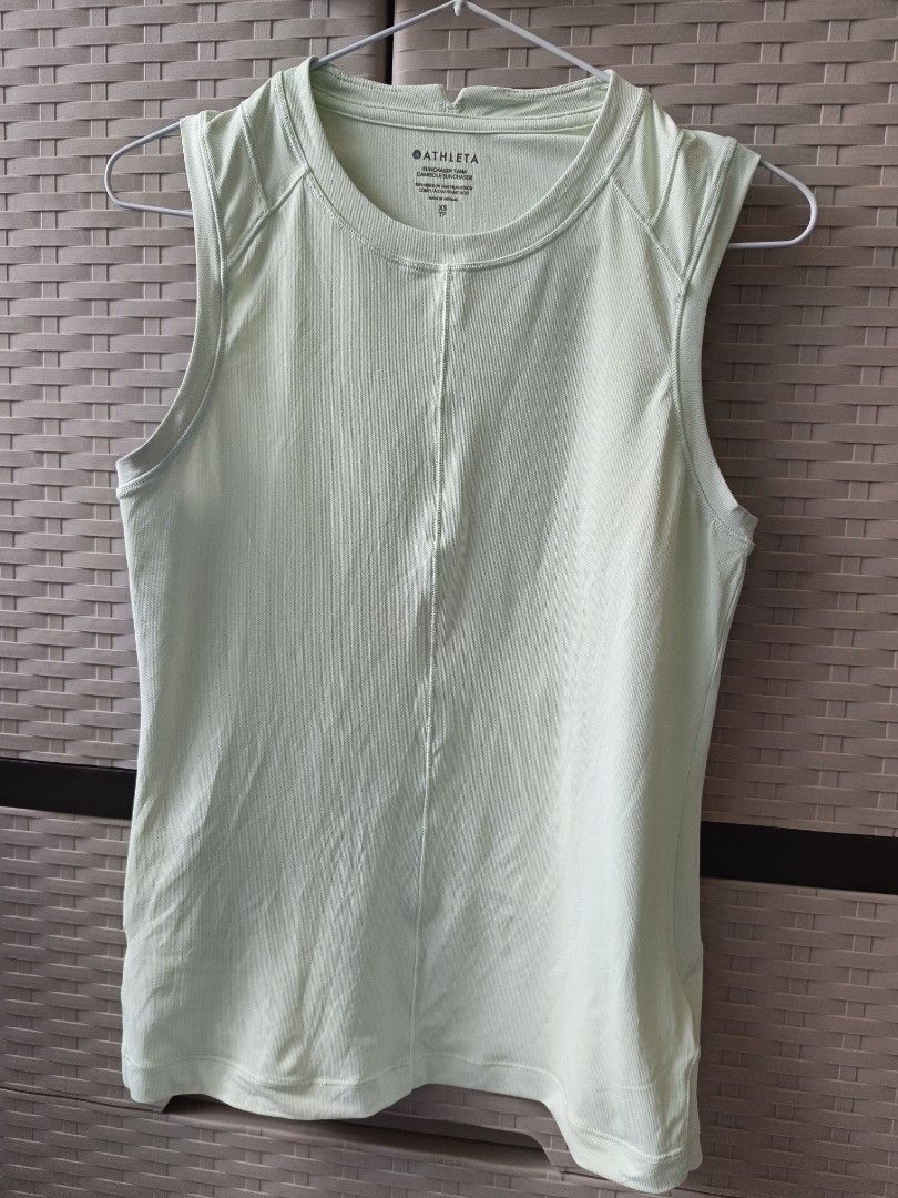 Athleta Sunchaser Tank Top Size XS (Category: Sleeveless) located in Cabanatuan. Submitted by lyxyx (Listing ID 1467713221, Image 1). Description: - Brand: Athleta - Style: Sunchaser tank top - Color: Pale green - Size: XS - Material: Lightweight ribbed texture - Design details: Crew neckline with small collar cutout, center vertical front seam - Origin: Designed in San Francisco, made in Vietnam.