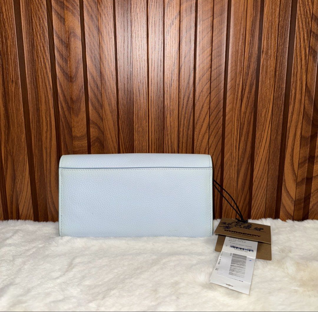 Authentic Burberry TB Wallet Grainy Leather Pale Blue (Category: Luxury Bags & Wallets) located in Subic. Submitted by luxshoppe88 (Listing ID 1467681674, Image 3). Description: - Brand: Burberry - Condition: like new with original store tags attached - Material: Premium pale blue grainy leather - Hardware: Polished Thomas Burberry monogram clasp & gold foil logo - Interior: Matching blue leather lining - Features: Multiple card slots and a secur
