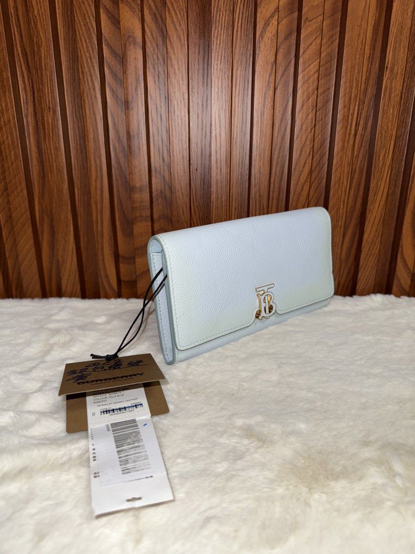 Authentic Burberry TB Wallet Grainy Leather Pale Blue (Category: Luxury Bags & Wallets) located in Subic. Submitted by luxshoppe88 (Listing ID 1467681674, Image 2). Description: - Brand: Burberry - Condition: like new with original store tags attached - Material: Premium pale blue grainy leather - Hardware: Polished Thomas Burberry monogram clasp & gold foil logo - Interior: Matching blue leather lining - Features: Multiple card slots and a secur