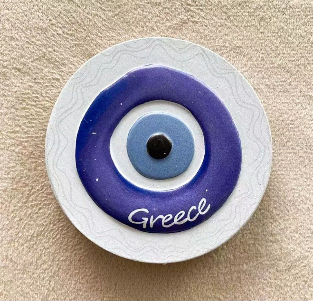 Authentic Greece Evil Eye (Mati) Fridge Magnet (Category: Vintage Collectibles) located in Pasig City. Submitted by swipeandpicks (Listing ID 1467811307, Image 2). Description: • Material: High-quality Resin / Plaster composite with a strong, secure magnetic back. • Texture/Finish: Glossy, vibrant UV-printed graphic layer with a smooth protective coating. • Colors: Cobalt Blue, Sky Blue, Crisp White, and Deep Black—the exact traditional shades re