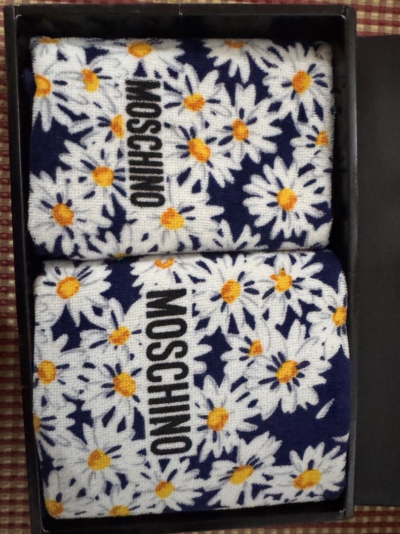 Authentic Moschino Daisy Pattern Towel Set with Box (Category: Bedding & Towels) located in Manila. Submitted by cheesetinefinds (Listing ID 1467612173, Image 3). Description: - Authentic Moschino towel set - Includes 2 soft cotton towels - Features a blue and white daisy floral design with bold black logo lettering - Brand new with tags attached - Comes in the original black branded box - Ideal luxury bathroom accessory or ready-to-give gift.