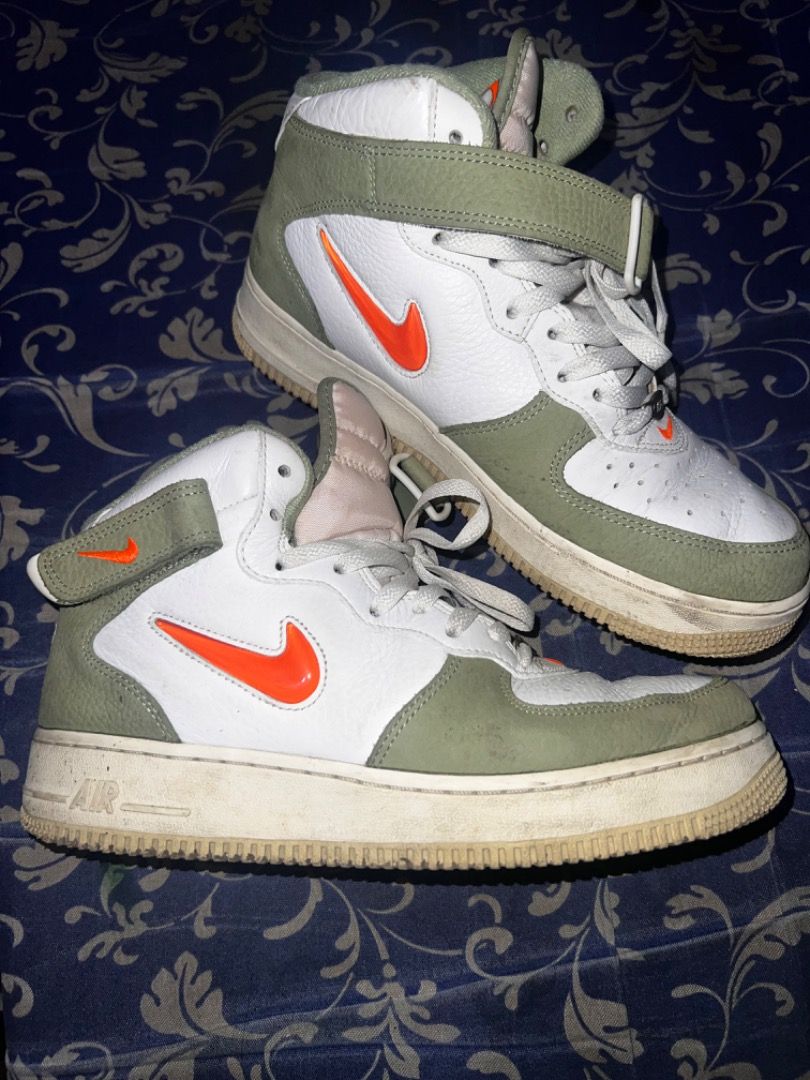 Authentic Nike Air Force 1 High Olive Green Orange (Category: Sneakers) located in Caloocan City. Submitted by mherckyyragkee (Listing ID 1467783313, Image 1). Description: - Brand: Nike - Style: High top sneakers - Colorway: Olive green overlays with white tumbled leather - Accents: Vibrant orange Swoosh and strap, brown embroidered heel branding - Features: Padded fabric tongue, matching tongue tag, and includes ankle strap - Condition: White m