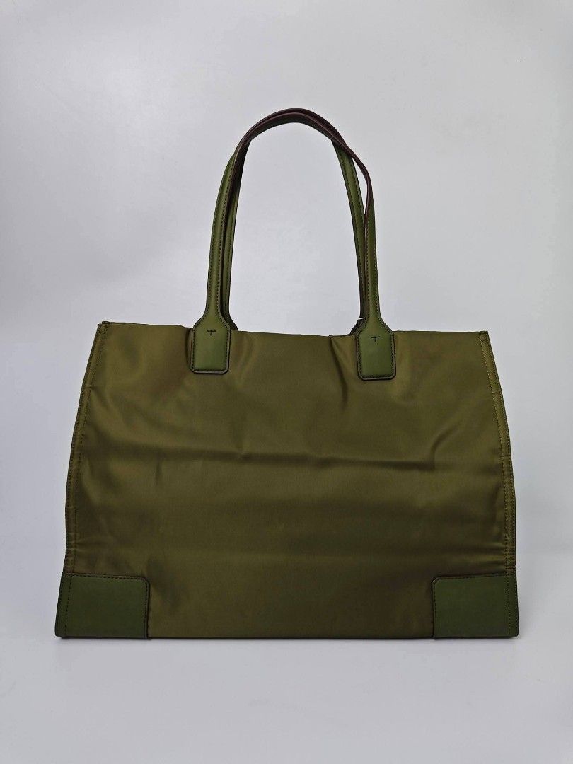 Authentic Tory Burch Olive Green Nylon Tote Bag (Category: Tote Bags) located in Quezon City. Submitted by hollowwillow (Listing ID 1467616468, Image 3). Description: - Brand: Tory Burch - Condition: Brand new - Material: Durable green nylon with leather trim - Design: Large embroidered logo on the front - Straps: Comfortable double shoulder straps - Interior: Spacious with multiple zip and slip pockets for easy organization - 100% Authentic and 